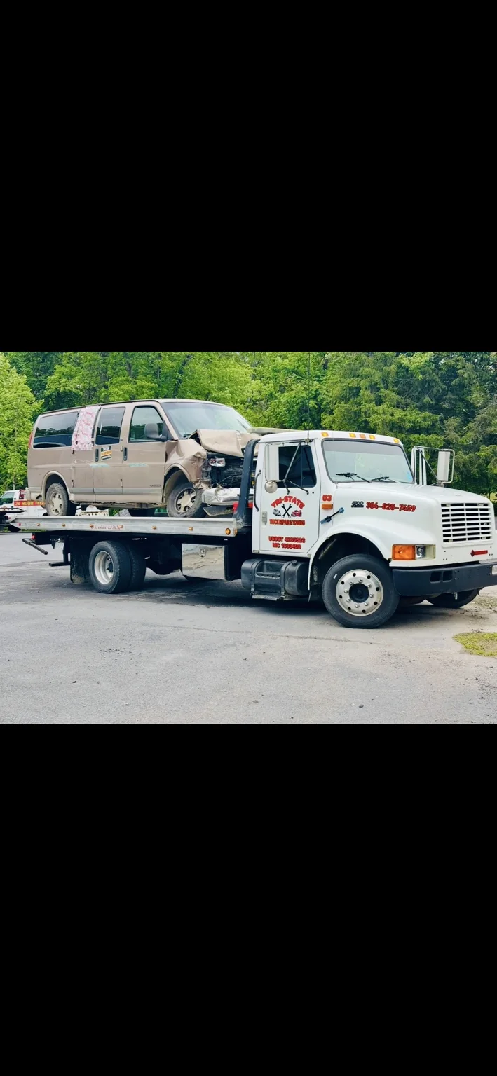 Tri-State International rollback towing a vehicle