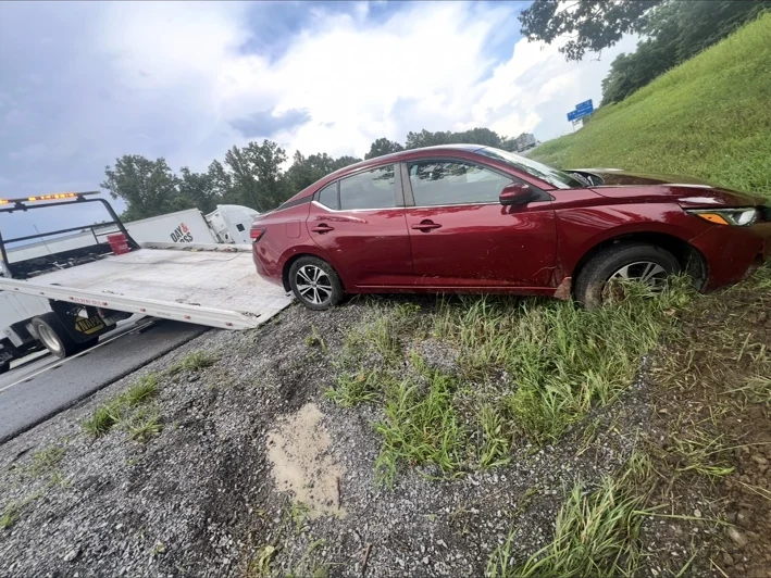 Tri-State rollback recovering a vehicle from the roadside